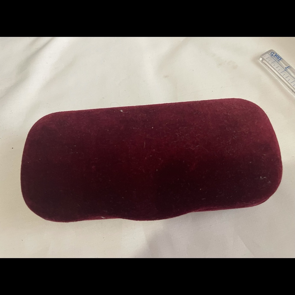 Burgundy Gucci eyeglasses case.